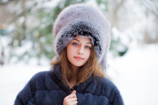 Beautiful young girl in a blue fur hat