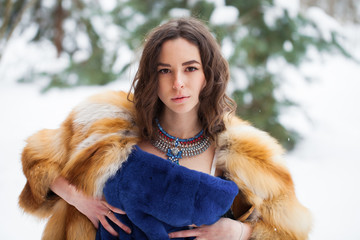 Beautiful elegant brunette woman wearing fur coat