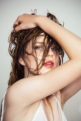 Naklejka premium Girl with lipstick on lips. Hair recover. Fashion portrait of woman. Woman with brittle hair. Beauty salon and hairdresser. Hair loss and care. Wet hair. Beautiful female. Loving her new style