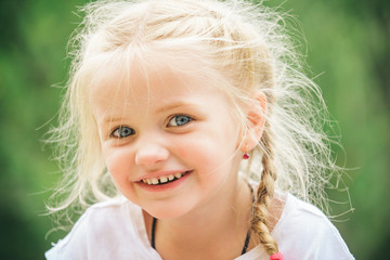 Life is about being happy. Small child happy smiling. Little girl wear hair in plaits. Small girl with blond hair. Happy little child with adorable smile. Good head of hair