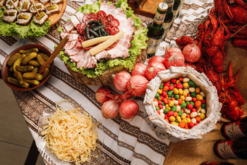 Catering banquet table with different food snacks and appetizers