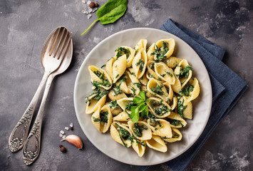 Conchiglioni pasta with spinach in creamy sauce