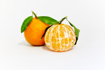 Photograph of a couple of tangerinewith with leaf isolated in studio with white background