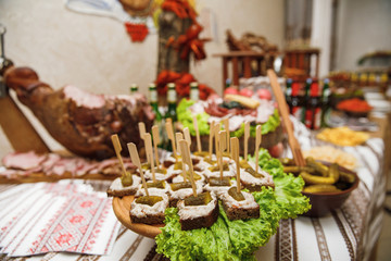 Catering banquet table with different food snacks and appetizers