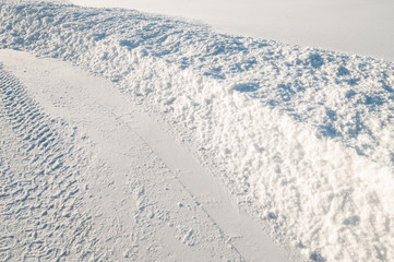 Car tire tracks in fresh snow