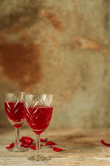 red wine in a glass and flowers on a wooden background. top view.