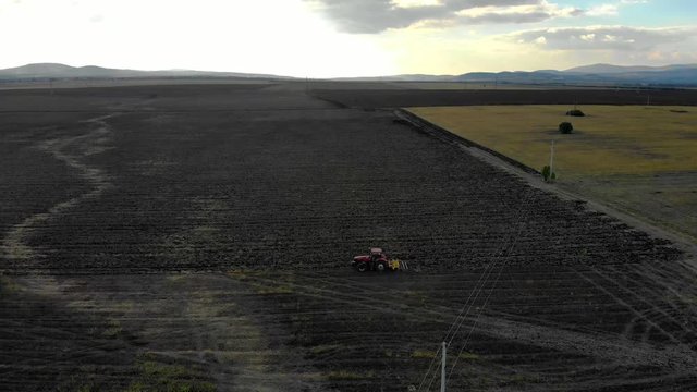 Aerial of tractor plowing the field.