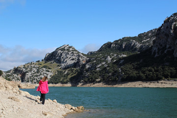 Women hiking around lake in mountains