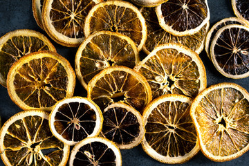 Sliced dried lemon and orange on dark background. Top view.