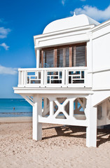 White building located on the beach in the cove in the Spanish city of Cadiz in a winter day 