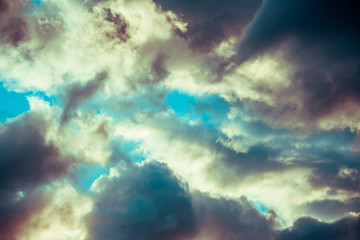 Fototapeta na wymiar dark clouds on a blue sky at sunset or sunrise.
