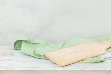 Napkin cloth and cutting board on gray wooden table