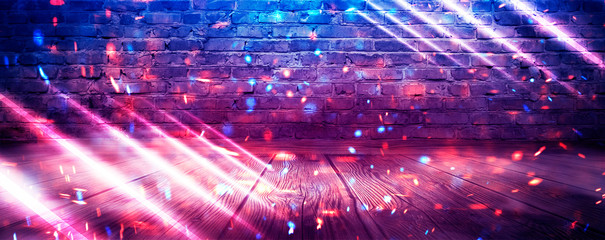 Fototapeta premium Empty brick wall background, night view, neon light, rays. Celebratory background. smoke