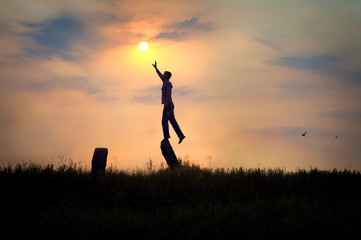 man reaches out to the sun