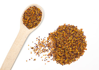 Bee pollen in the wooden spoon on white background