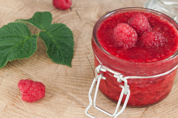 Glass jar with raspberry jam
