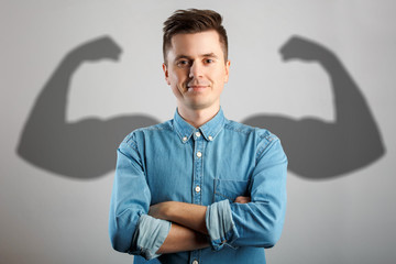 Man has shadow with strong arms