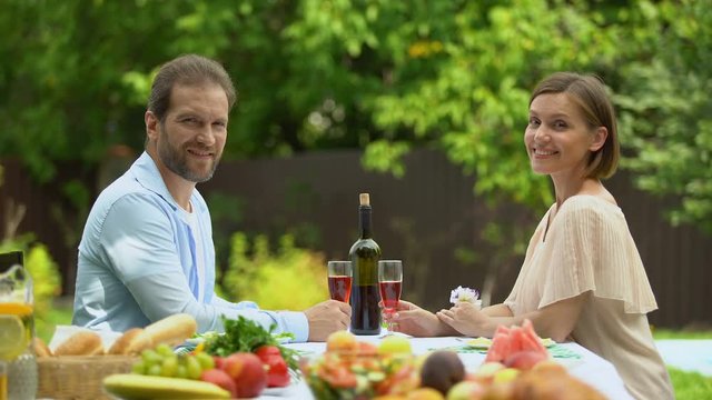 Happily married having glasses of wine in own contry house, credit financing