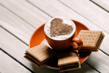 photo of the cup of coffee and cookies on the white wooden background
