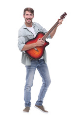 in full growth.young male musician with guitar