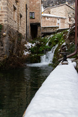 Winter scene with snowy waterfall in Burgos, Spain