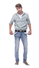 Fototapeta premium in full growth.young man showing his empty pockets