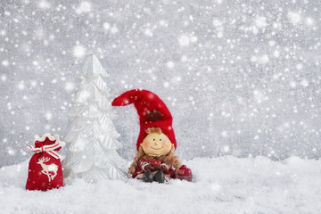 Christmas greeting card. Decorative Christmas fir tree and gnome in snow. Copy space