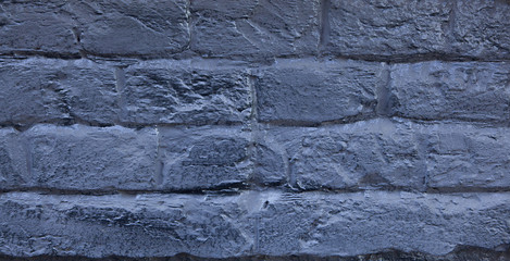 The brick wall painted in blue. Background of old vintage blue brick wall. Blue brick wall .Street light dark blue brick wall