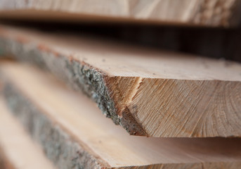 Folded wooden planks in a sawmill. Piled boards as texture