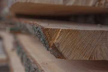 Folded wooden planks in a sawmill. Piled boards as texture