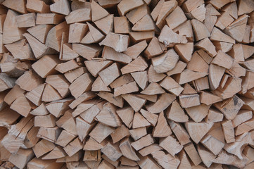 Material for heating the house. Preparation of firewood for the winter. background of firewood. A pile of firewood