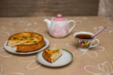 Still life with tea cup, piece of pie, plate, teapot