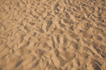 Closeup of sand pattern of a beach in the summer. Background concept