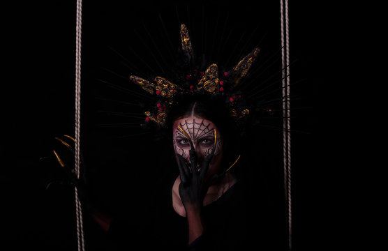 Closeup portrait of Calavera Catrina. Young woman with sugar skull makeup. Dia de los muertos. Day of The Dead. Halloween.