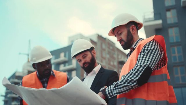 Big boss senior manager briefing, discussion, meeting or safety morning talk plan with engineer, foreman, labor worker before starting build factory, plant, industry project. Cooperation