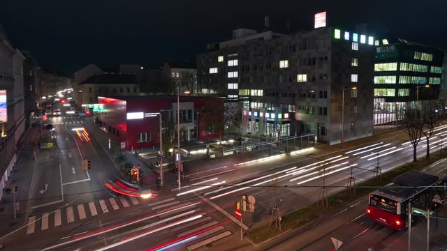 Aerial view time-lapse of nightly traffic with car light trails on the Waehringer Guertel road intersection with Gentzgasse in Vienna.