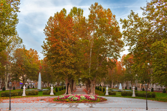 View of the famous Zrinjevac park in down town of Zagreb, Croatia, during autumn with statues, music pavilion, and water fountains. 