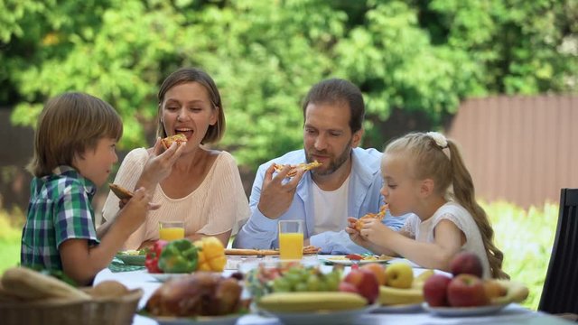 Enjoying taste fresh baked pizza, family dining together, food delivery service