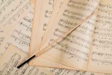 Wand On Music Notes Sheets And Music Book Background