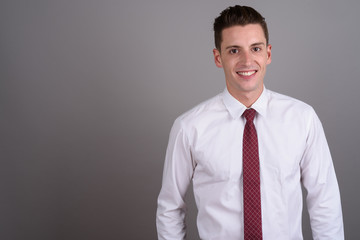 Young handsome businessman smiling and looking at camera