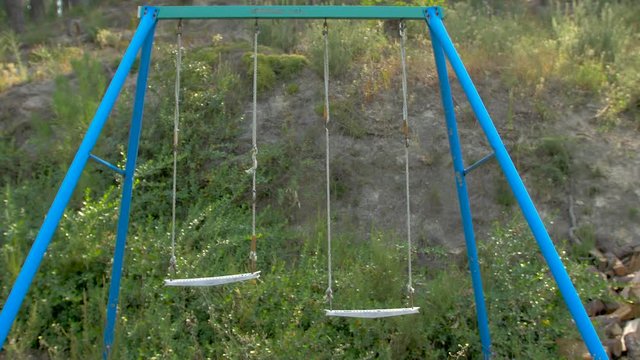Abandoned swing in a wild camp