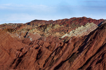 Zhangye Danxia National Geopark - Gansu Province, China. Chinese Danxia multicolor danxia landform, rainbow hills, rainbow mountains, sandstone erosion, layers of Red, Yellow and Orange stripes.