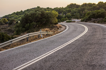 empty small highway country side road in landmark nature hill environment in evening between sunset 