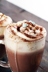 Hot chocolate cocoa with whipped cream on table.