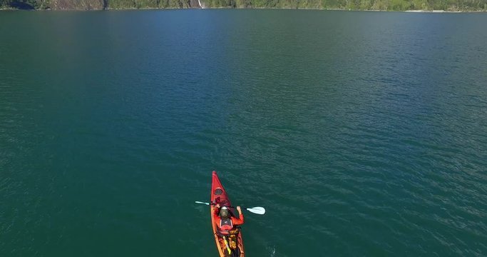 Man in kayak navigating the Tagua Tagua lake and its surroundings on a sunny day