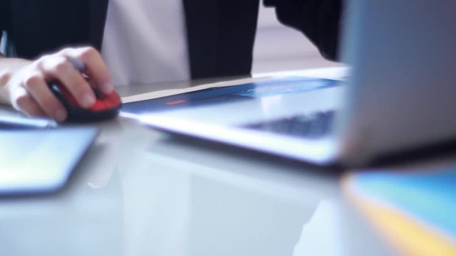 Graphist at work on a glass table.