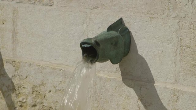 Fountain detail representing a fish with an opne mouth filmed in Lisbon, Portugal