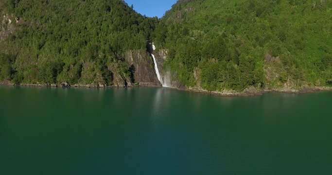 Aerial view of the landscape surrounding Lake Tagua Tagua, where you can see a waterfall with abundant water coming from the mountains