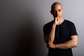 Stressed handsome bald man looking worried while thinking