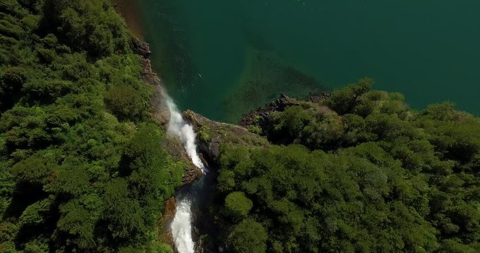 Aerial view of the Velo de la Novia waterfall that flows into Lake Tagua Tagua, surrounded by native forest